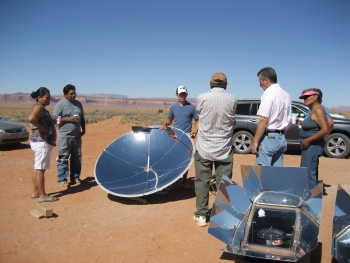 Roger and wife learning about the Solar Burner