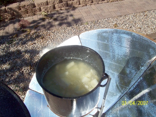 solar cooker boiling potatoes