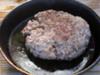 Cooked lamb burger in pan.